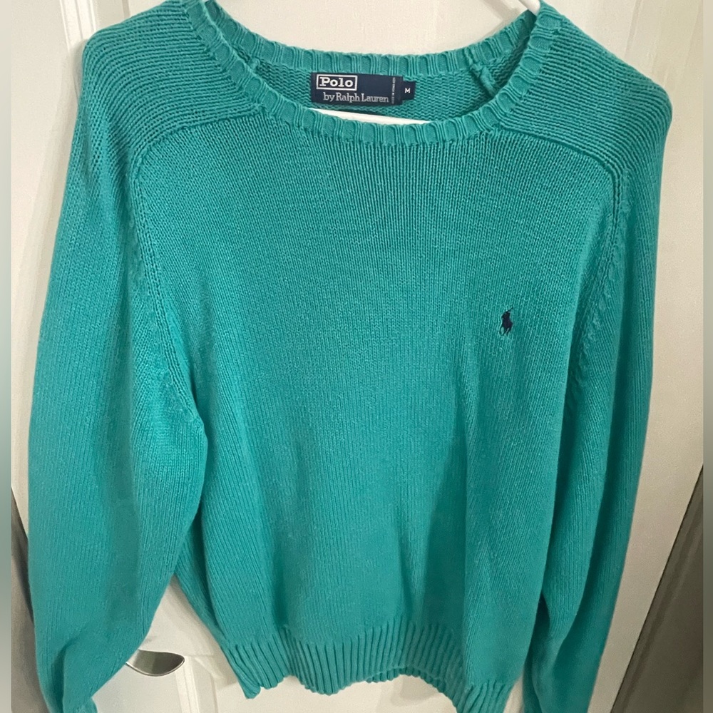 Teal colored polo sweater Size medium but fits a large.